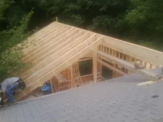 Framing a new roof addition that ties into an existing shingle roof in Whitewater